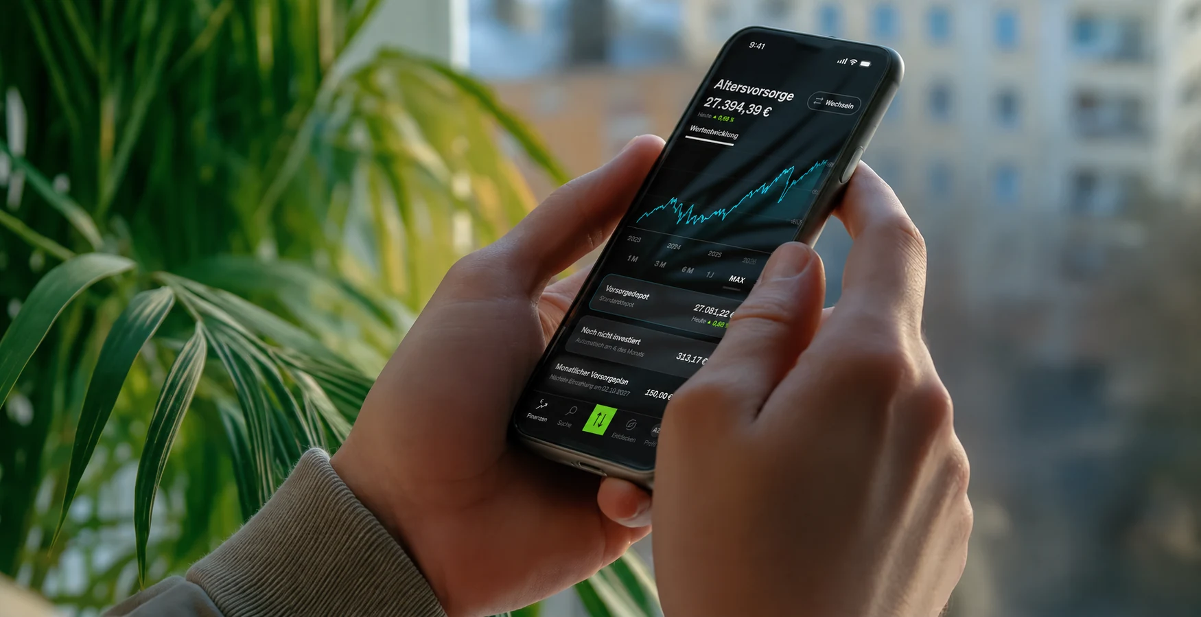 Phone showing the SMARTBROKER+ retirement portfolio beside houseplants